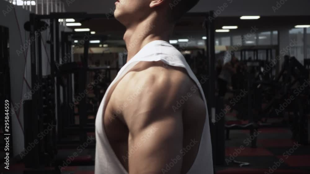 Lateral raise with dumbbells of fit guy, close up, slow motion Lateral raise with dumbbells of fit guy, close up, slow motion