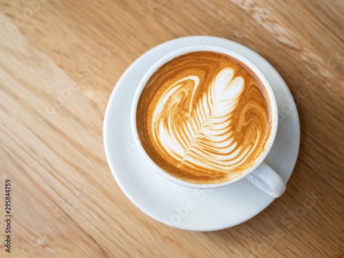 Nice heart tree shape of hot latte art serve on vintage wooden plate