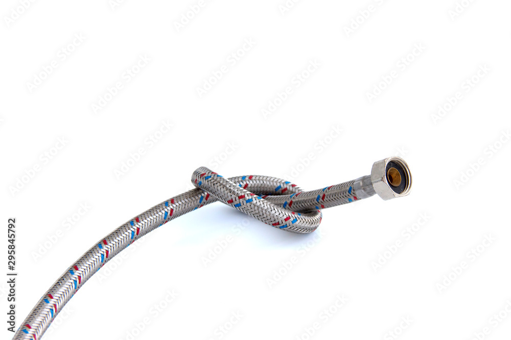 The water inlet hose tap metal braid, tied in a knot isolated on white.