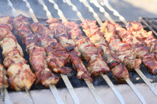 Mixed grilled meat platter. Assorted delicious grilled meat. The closeup of some meat skewers being grilled in a barbecue. grilled meat skewers, barbecue.