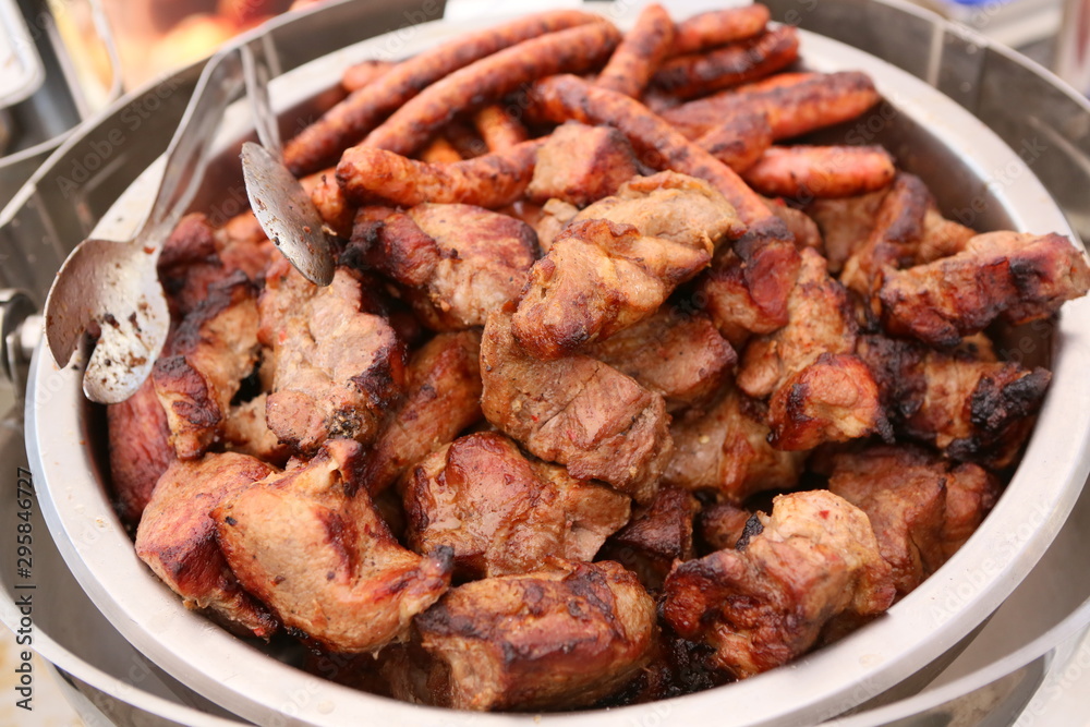 Mixed grilled meat platter. Assorted delicious grilled meat. The closeup of some meat skewers being grilled in a barbecue. grilled meat skewers, barbecue. Mixed grilled meat platter. Assorted delicious grilled meat. The closeup of some meat skewers being grilled in a barbecue. grilled meat skewers, barbecue.