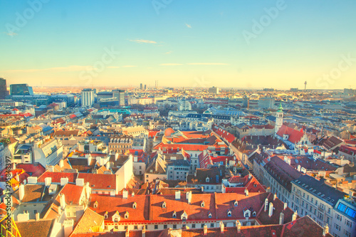 Panoramic view to Stephansplatz and Vienna center, a lot of orange tile roofs. Beautiful bright colors. Vienna, Austria. 