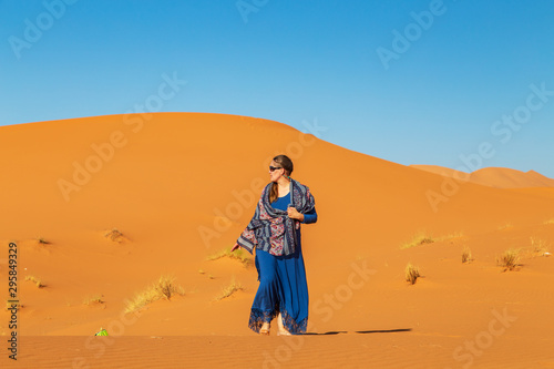 Beautiful girl in the Sahara desert.