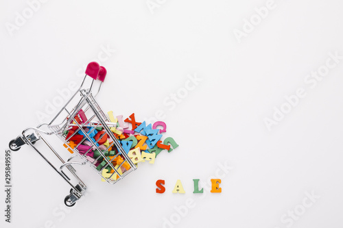 Overturned shopping cart filled with letters