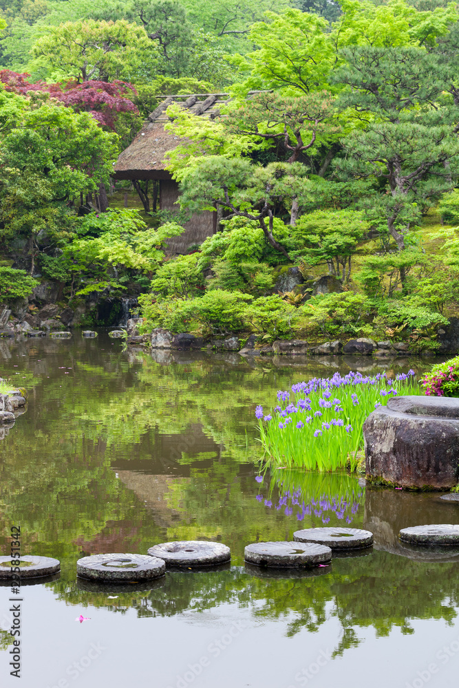 Circular stepping stones across a pond in a traditional Japanese garden. Selective focus on stones. Circular stepping stones across a pond in a traditional Japanese garden. Selective focus on stones.