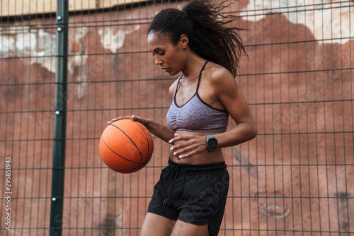 Attractive young african sportswoman playing basketball © Drobot Dean