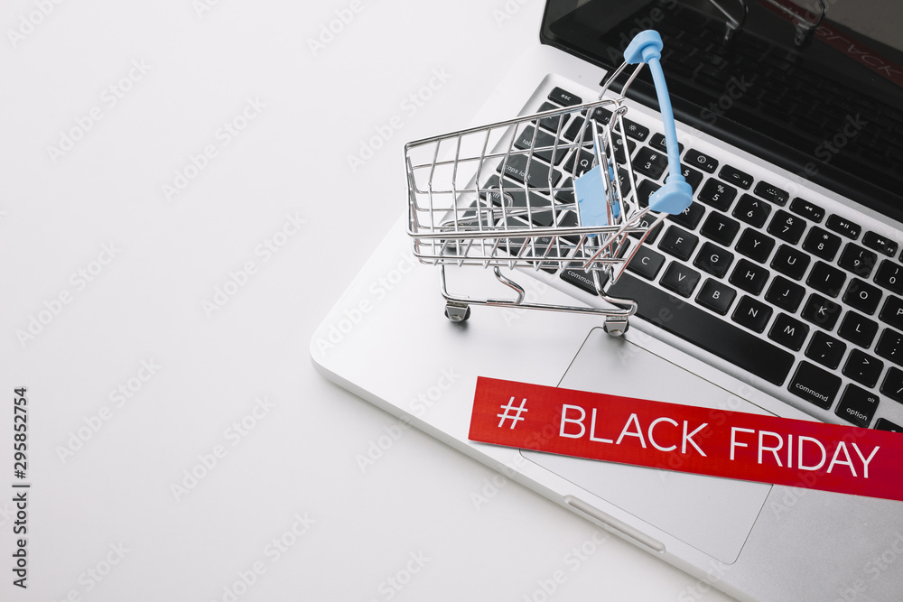 Black friday laptop and shopping cart with copy space