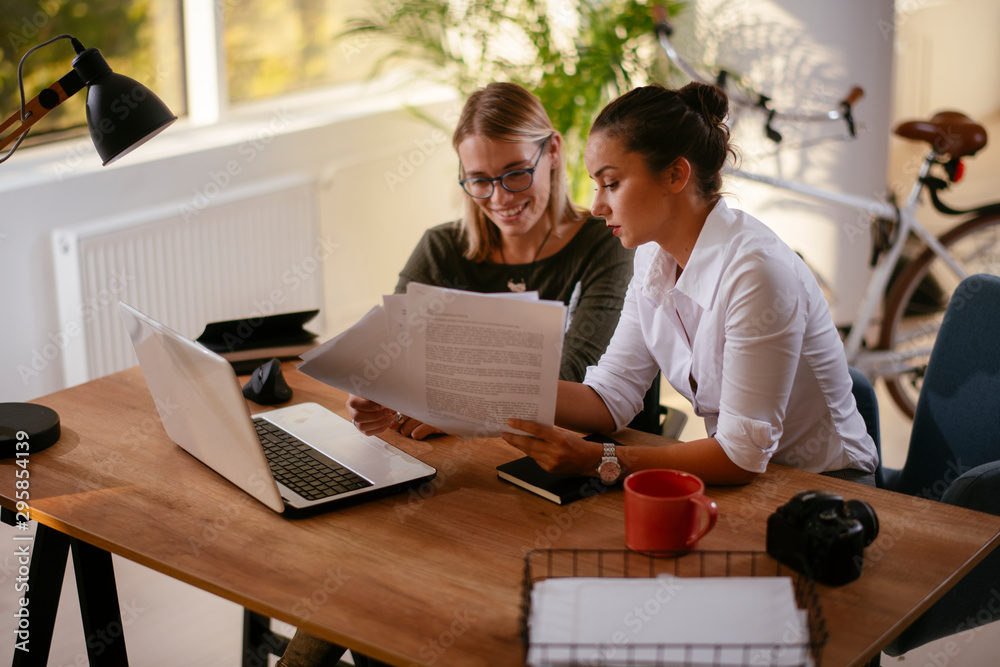 Businesswomen doing paperwork in the office Businesswomen doing paperwork in the office