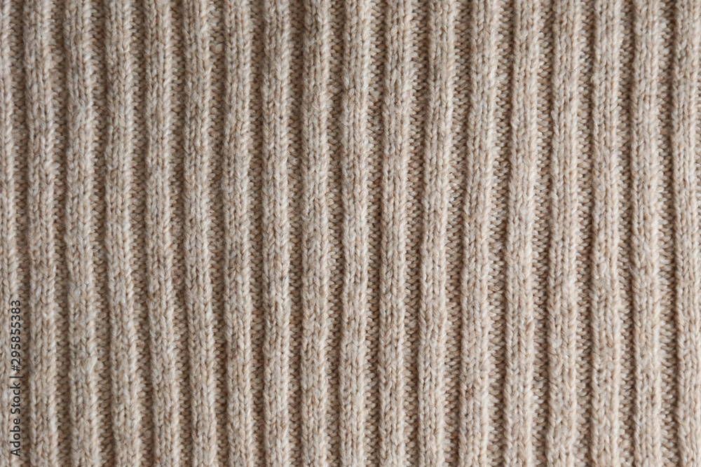 Cropped close up shot of seamless woolen knitting pattern of fall / winter season warm sweater, clearly visible fiber texture of stylish hipster knitwear clothing. Background, copy space, top view. Cropped close up shot of seamless woolen knitting pattern of fall / winter season warm sweater, clearly visible fiber texture of stylish hipster knitwear clothing. Background, copy space, top view.