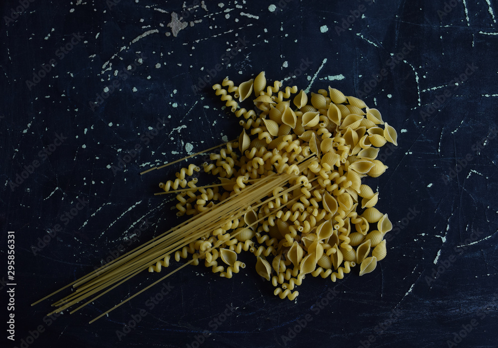 pasta of different shapes on a dark background pasta of different shapes on a dark background