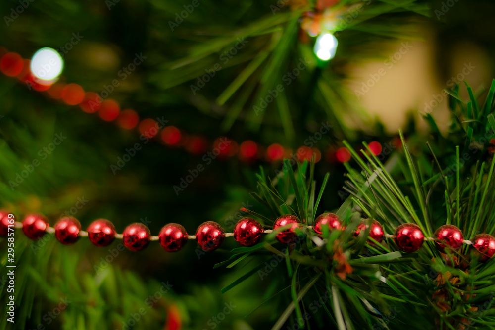 Chain of little red balls in a christmas tree Chain of little red balls in a christmas tree