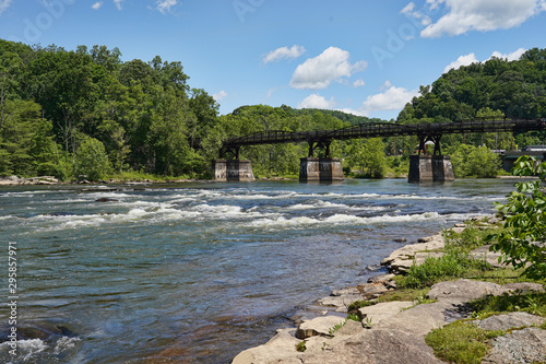 View of the white rapids, river, and bridge at the Ohiopyle State Park in Pennsylvania. photo