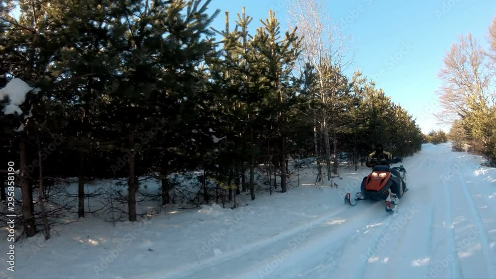 A rider on the snowmobile. Beautiful winter day in mountains A rider on the snowmobile. Beautiful winter day in mountains