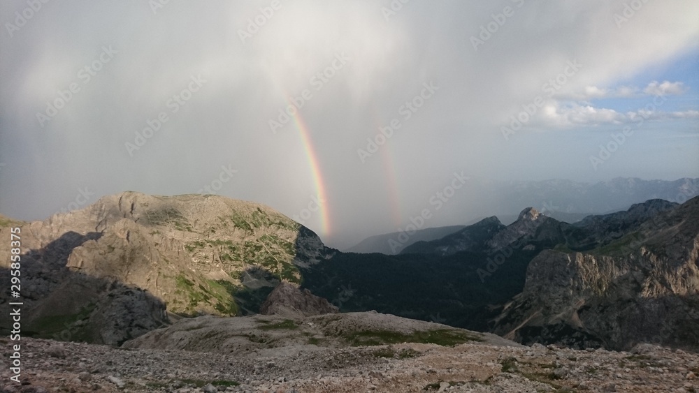 Rainbow with clouds and mist in the mountains of Triglav National Park, Slovenia