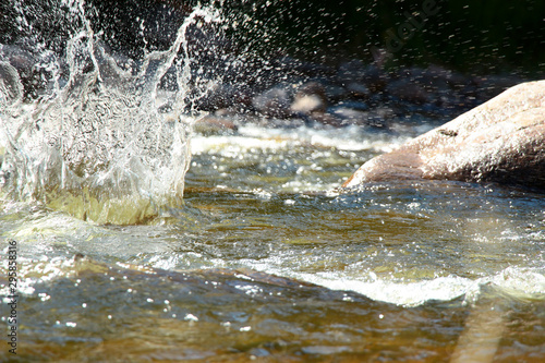 Splash of water from falling stone
