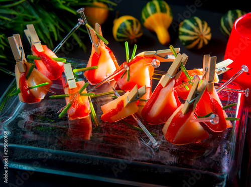 Slices of Patagonian toothfish fillet marinated in beet brandy with marinated baked bell pepper photo