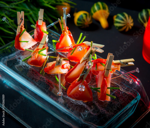 Slices of Patagonian toothfish fillet marinated in beet brandy with marinated baked bell pepper photo