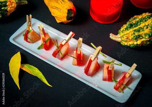 Slices of Patagonian toothfish fillet marinated in beet brandy with marinated baked bell pepper photo