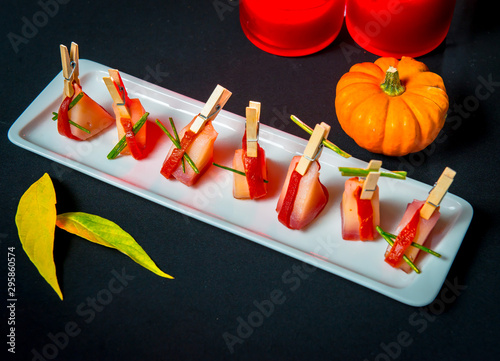 Slices of Patagonian toothfish fillet marinated in beet brandy with marinated baked bell pepper photo