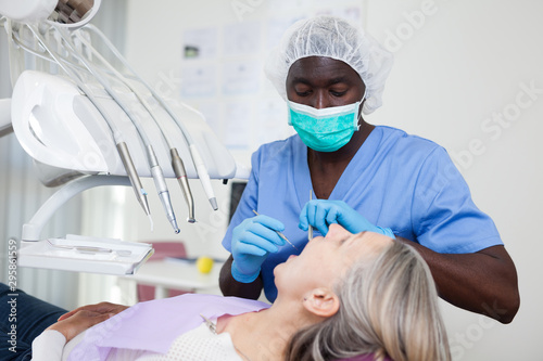 Fotografie Mature female patient sitting in dental chair