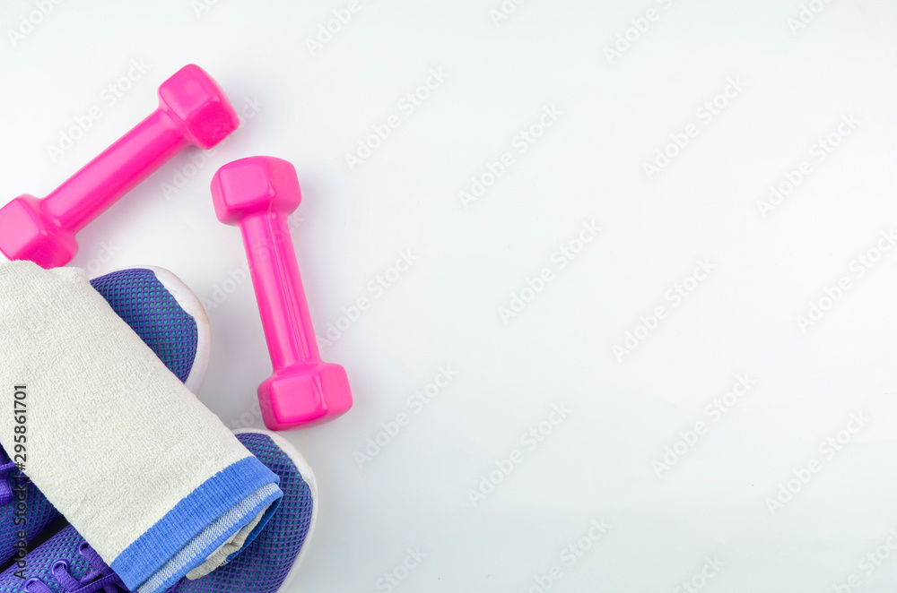 Fitness concept background with sneakers, dumbbells and towel. Top view with space for your text. Fitness concept background with sneakers, dumbbells and towel. Top view with space for your text.