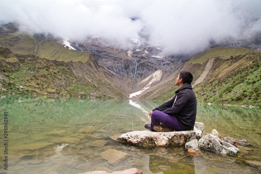 man in front of the Humantay Lake on the Salkantay Trail, the trek to Machu Picchu, Peru man in front of the Humantay Lake on the Salkantay Trail, the trek to Machu Picchu, Peru