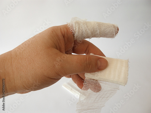 cut index finger. processed with a bandage. white background