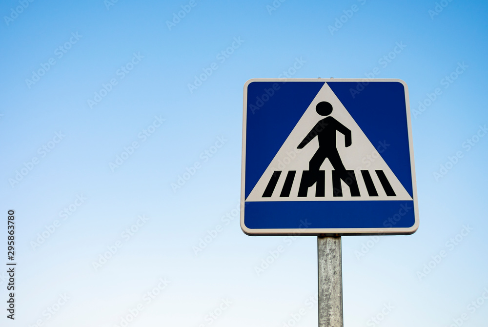 Vertical signage of crosswalk over clear sky Vertical signage of crosswalk over clear sky