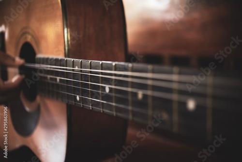 Close-up of of brown wooden acoustic classical guitar.