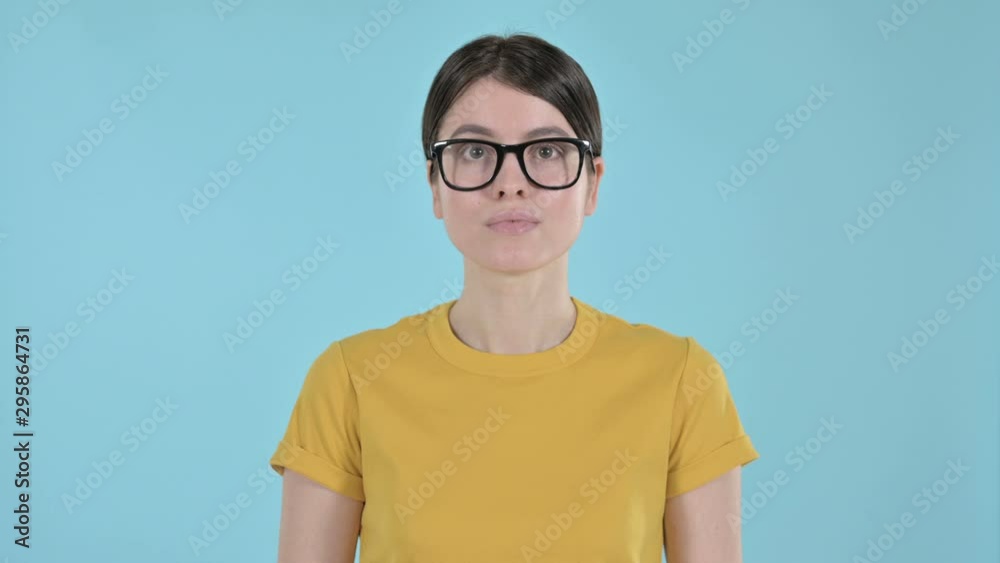 Serious Young Woman Looking at the Camera on Purple Background Serious Young Woman Looking at the Camera on Purple Background