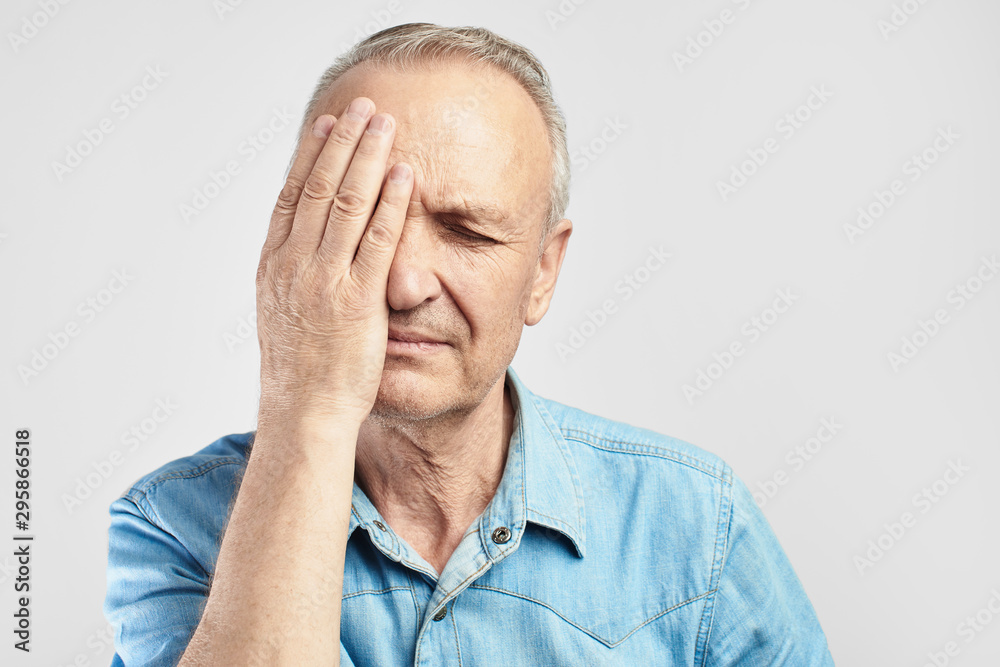 elderly gray-haired man with expression of pain on face put his hand on head, feels dizzy and cluster headache, migraine, high or low blood pressure isolated on white elderly gray-haired man with expression of pain on face put his hand on head, feels dizzy and cluster headache, migraine, high or low blood pressure isolated on white