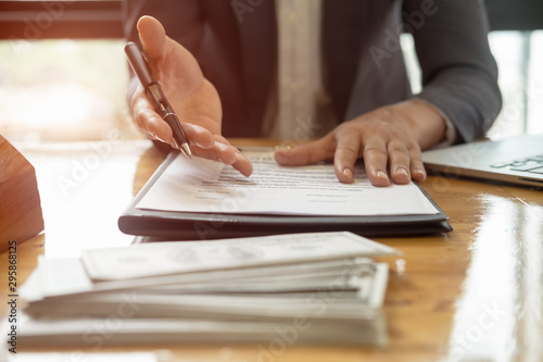 Close up business man reaching out sheet with contract agreement proposing to sign.Full and accurate details, individual who owns the business sign personally,director of the company, solicitor. photo