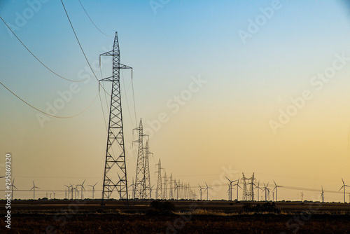 Un viento lejano con turbinas eólicas  en un entorno de puesta de sol poético, que sirve como una imagen perfecta para la energía verde sostenible renovable. photo