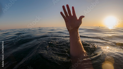 hand of a drowning man in the sea