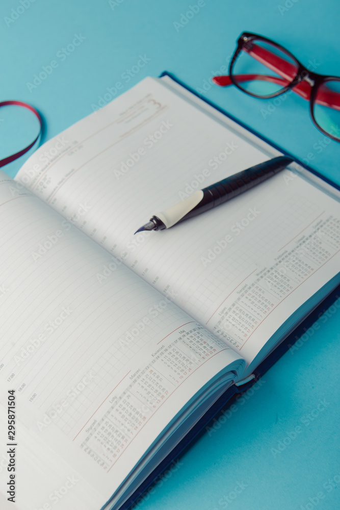 notebook on blue paper. open diary and pen to record notebook on blue paper. open diary and pen to record