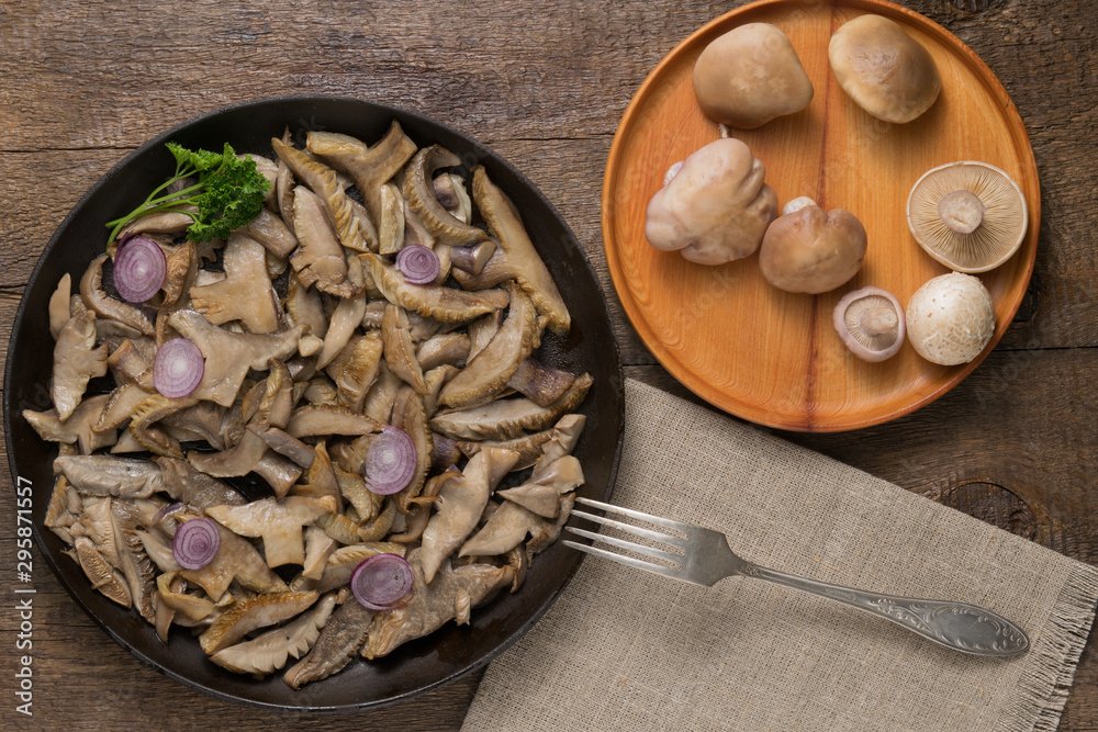Delicious fried mushrooms in pan on table Delicious fried mushrooms in pan on table