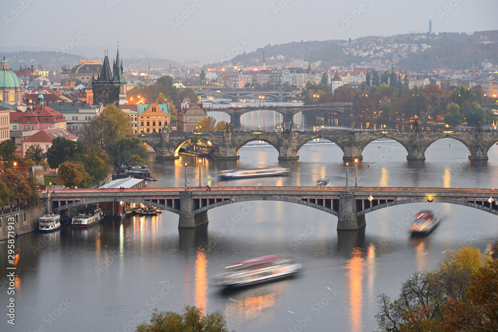 Prague bridges over Vltava river in historical part of the city. Autumn. Evening. Cloudy sky. Fog. Prague, Czech Republic.