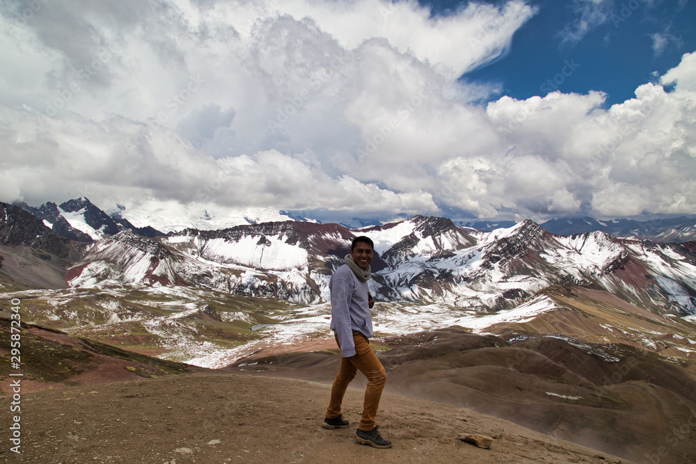 Man with panoramic view. Hiking scene in Vinicunca, Cusco region, Peru. Montana of Seven Colors, Rainbow Mountain