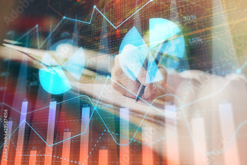 Wallpaper Mural Financial forex graph displayed on hands taking notes background. Concept of research. Multi exposure Torontodigital.ca