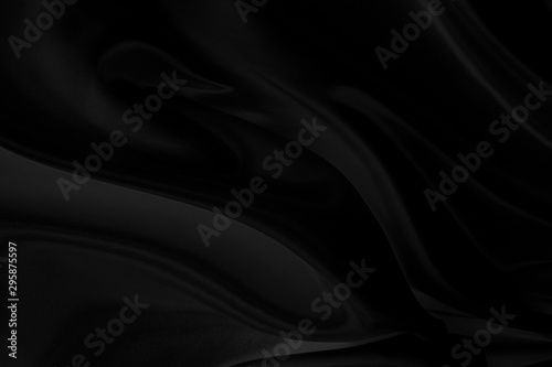 Black fabric texture that is black silk background with beautiful soft blur pattern.