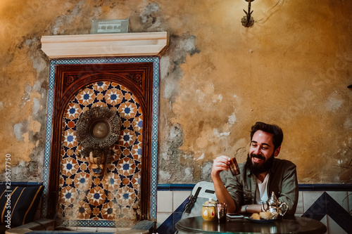 Cuadro en lienzo .Young handsome tourist enjoying a moment alone in a Moroccan style tea shop. Dr