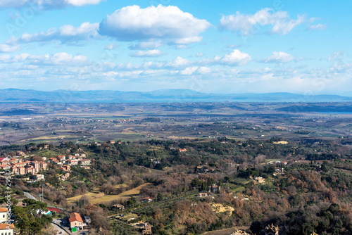 Picturesque winter landscape view of Tuscany with stone houses, colorful hills, fields and vineyards in Italy.