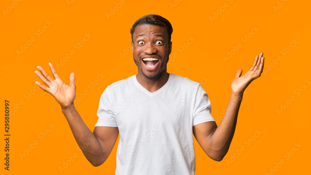 Surprised African American Man Shouting Looking At Camera, Studio, Panorama Surprised African American Man Shouting Looking At Camera, Studio, Panorama