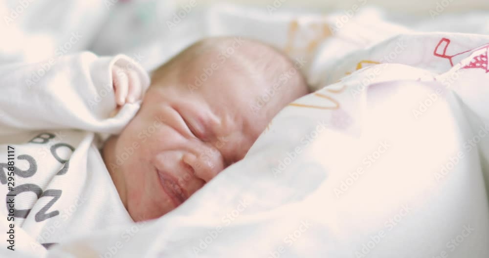 Upset baby whimpering and grimacing face needing in parent's attention