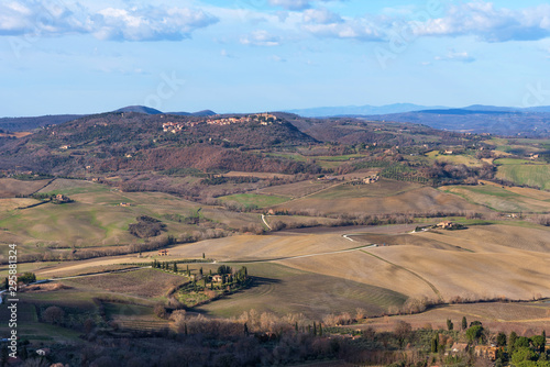 Picturesque winter landscape view of Tuscany with stone houses, colorful hills, fields and vineyards in Italy.