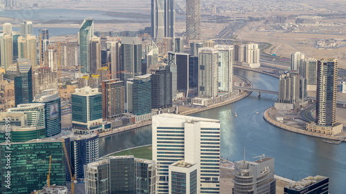 Panoramic aerial view of business bay towers in Dubai at evening timelapse.