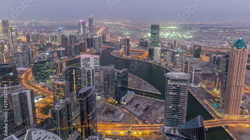 Panoramic aerial view of business bay towers in Dubai day to night timelapse.