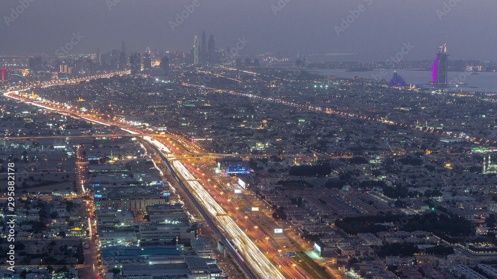 Aerial view to traffic on Sheikh Zayed road and intersection day to night timelapse, Dubai, United Arab Emirates