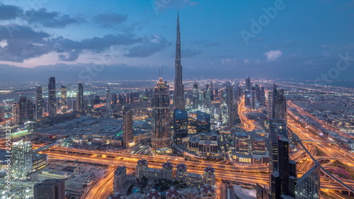 Dubai Downtown skyline futuristic cityscape with many skyscrapers and Burj Khalifa aerial night to day timelapse. © neiezhmakov