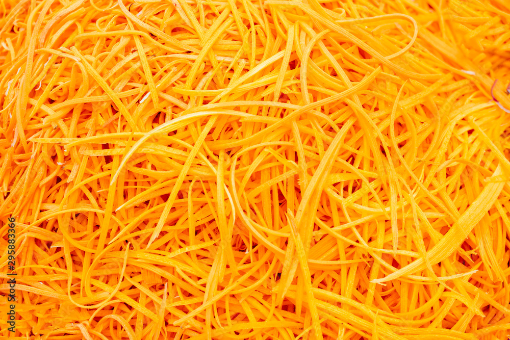 Grated raw carrots background. Raw korean asian salad carrots Grated raw carrots background. Raw korean asian salad carrots